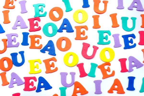 Colorful Random Vowels on White Background